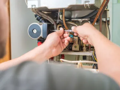 technician repairing furnace