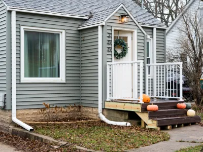 Tiny house with pumpkins on doorstep, Rochester, MN