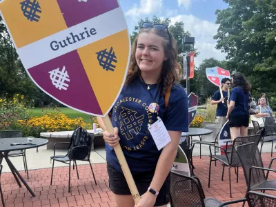 CUB intern Emma Henry holding a sign