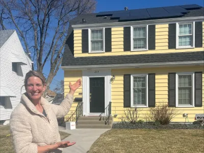 Sarah standing in front of her house