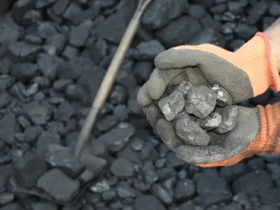 hands holding coal