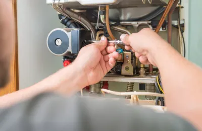 technician repairing furnace