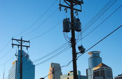 a powerline with the Minneapolis skyline in the background