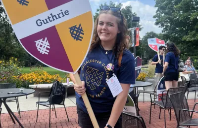 CUB intern Emma Henry holding a sign