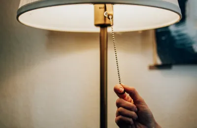 someone turning on a lamp