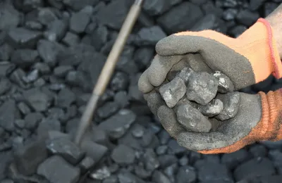hands holding coal