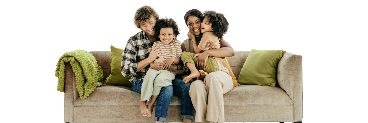 Family of four seated on a couch