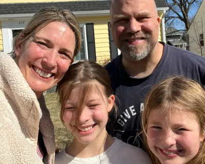 Sarah's family in front of their house