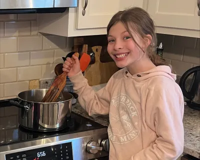 Sarah's daughter over an induction stove