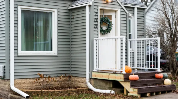 Tiny house with pumpkins on doorstep, Rochester, MN
