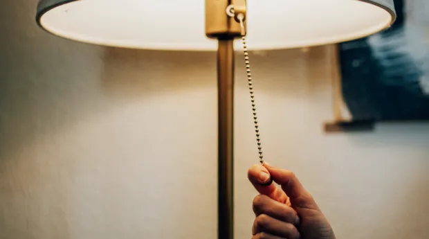 someone turning on a lamp