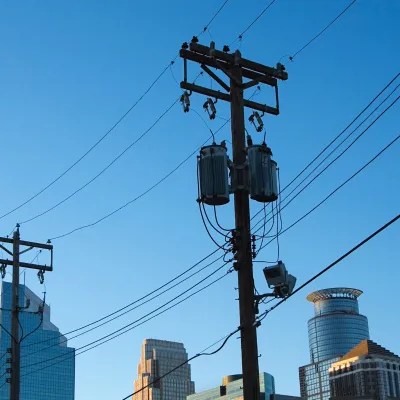 a powerline with the Minneapolis skyline in the background